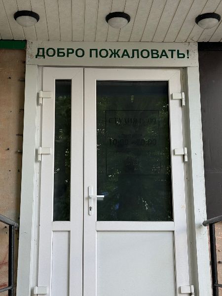 Тёмная наклейка на стеклянной двери почти не видна